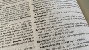 Photo of a page from the dictionary where the word dyslexia (among other words) is displayed.