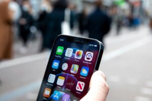 Photo of a mobile phone with just the person's hand holding it.
